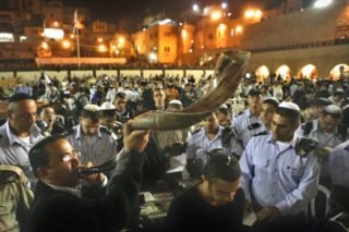 A Jewish orthodox man blows a 'Shofar' (ram's horn) while Hundreds of Jews , pray all night for forgiveness ( Selichot), at the the Western Wall, the holiest place where Jews can pray, in Jerusalem's Old City before the holiday of Rosh Hashanah.